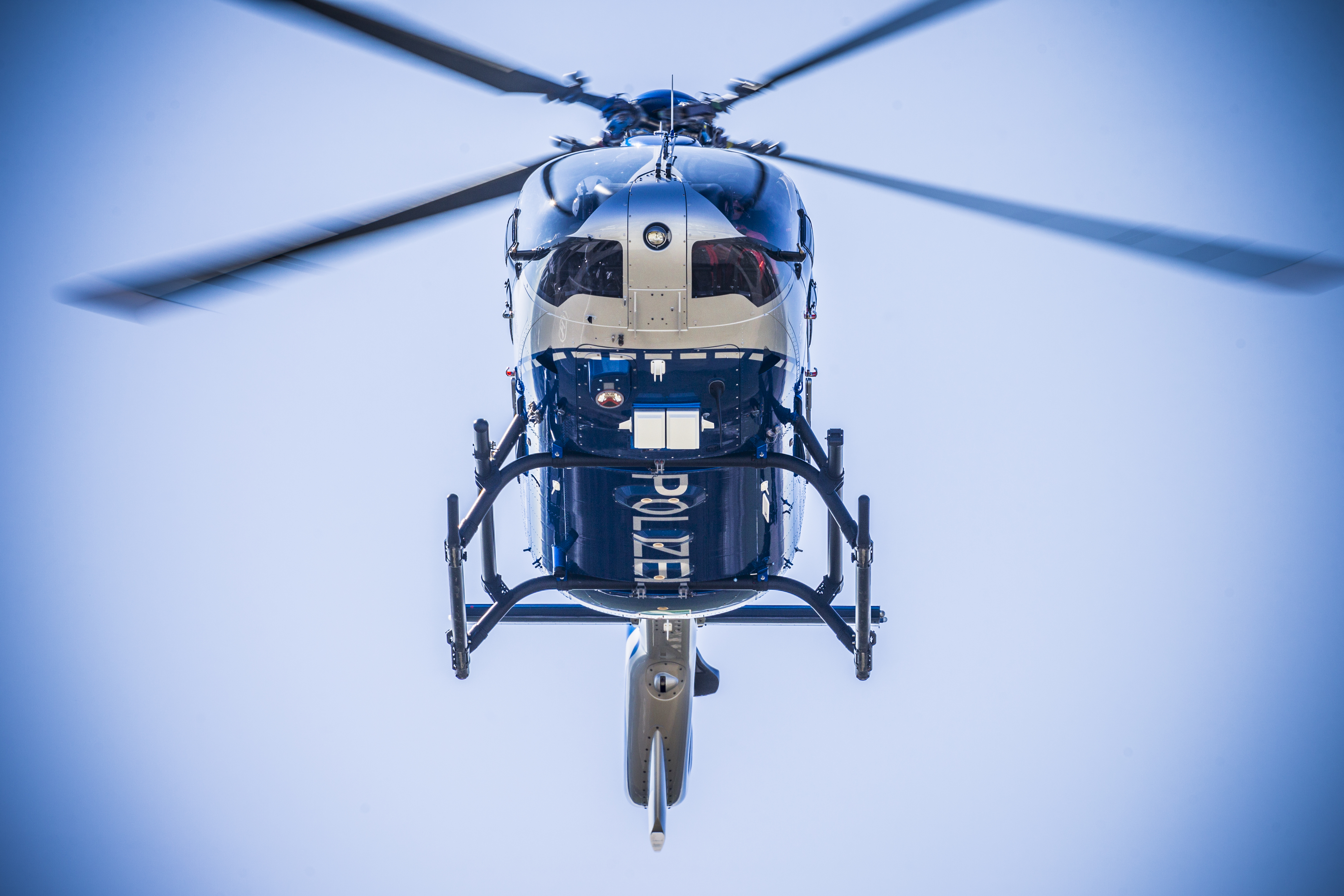 view from below of a flying police helicopter